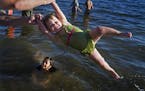 At Lake Harriet, unusually warm temperatures brought summer back if but for a day. Lillian Hebert,2, twirled around with dad Nick while friend Evelyn 