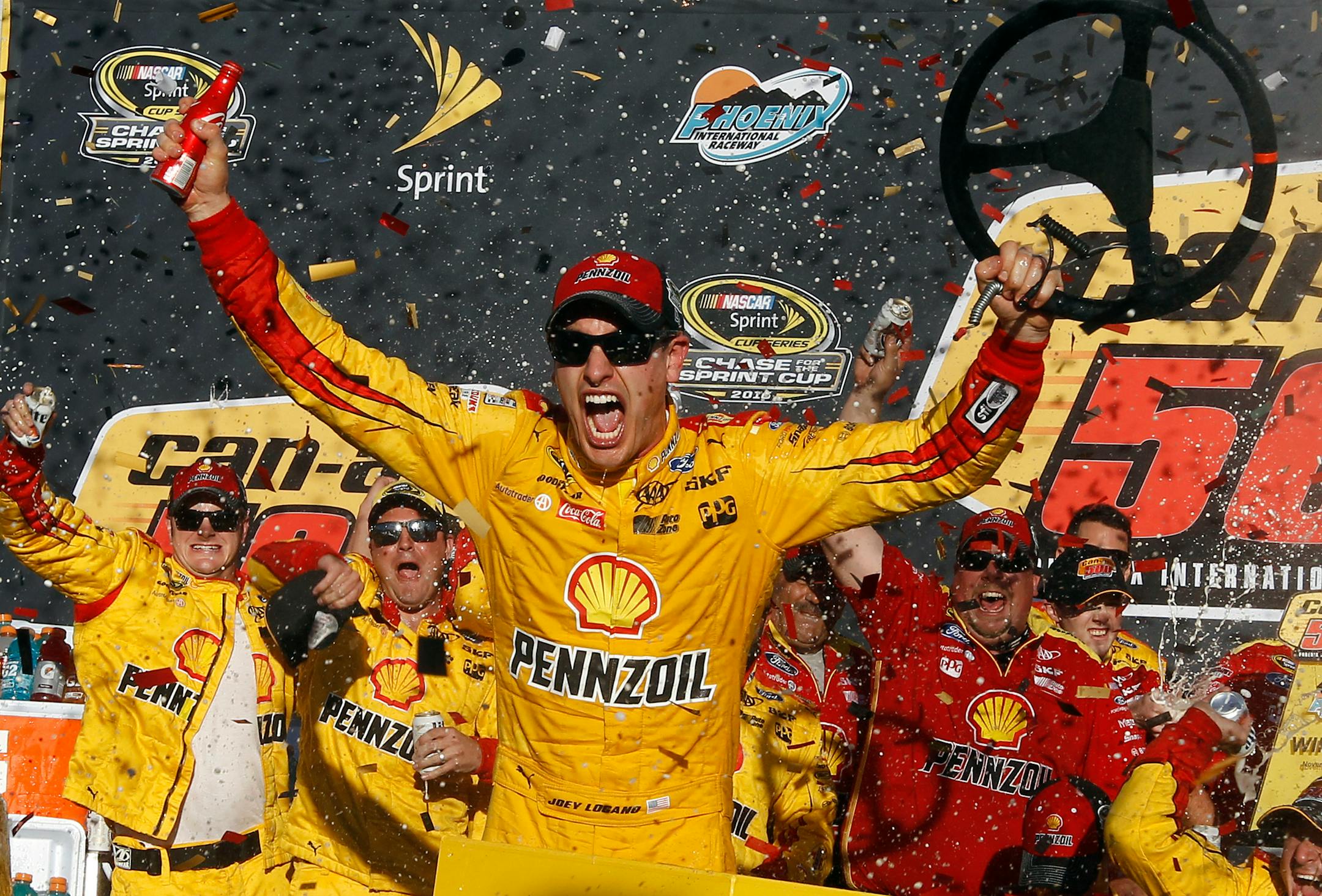 Joey Logano celebrates in the victory lane after winning the NASCAR Sprint Cup Series auto race at Phoenix International Raceway, Sunday, Nov. 13, 2016, in Avondale, Ariz. (AP Photo/Ralph Freso)