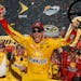 Joey Logano celebrates in the victory lane after winning the NASCAR Sprint Cup Series auto race at Phoenix International Raceway, Sunday, Nov. 13, 201