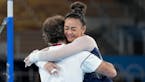 Suni Lee hugging her coach Jess Graba after her uneven bars routine in the women’s all-around competition.