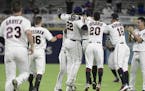The Minnesota Twins celebrate a 2-1 win over the Cleveland Indians in 16 innings in a baseball game at Hiram Bithorn Stadium in San Juan, Puerto Rico,