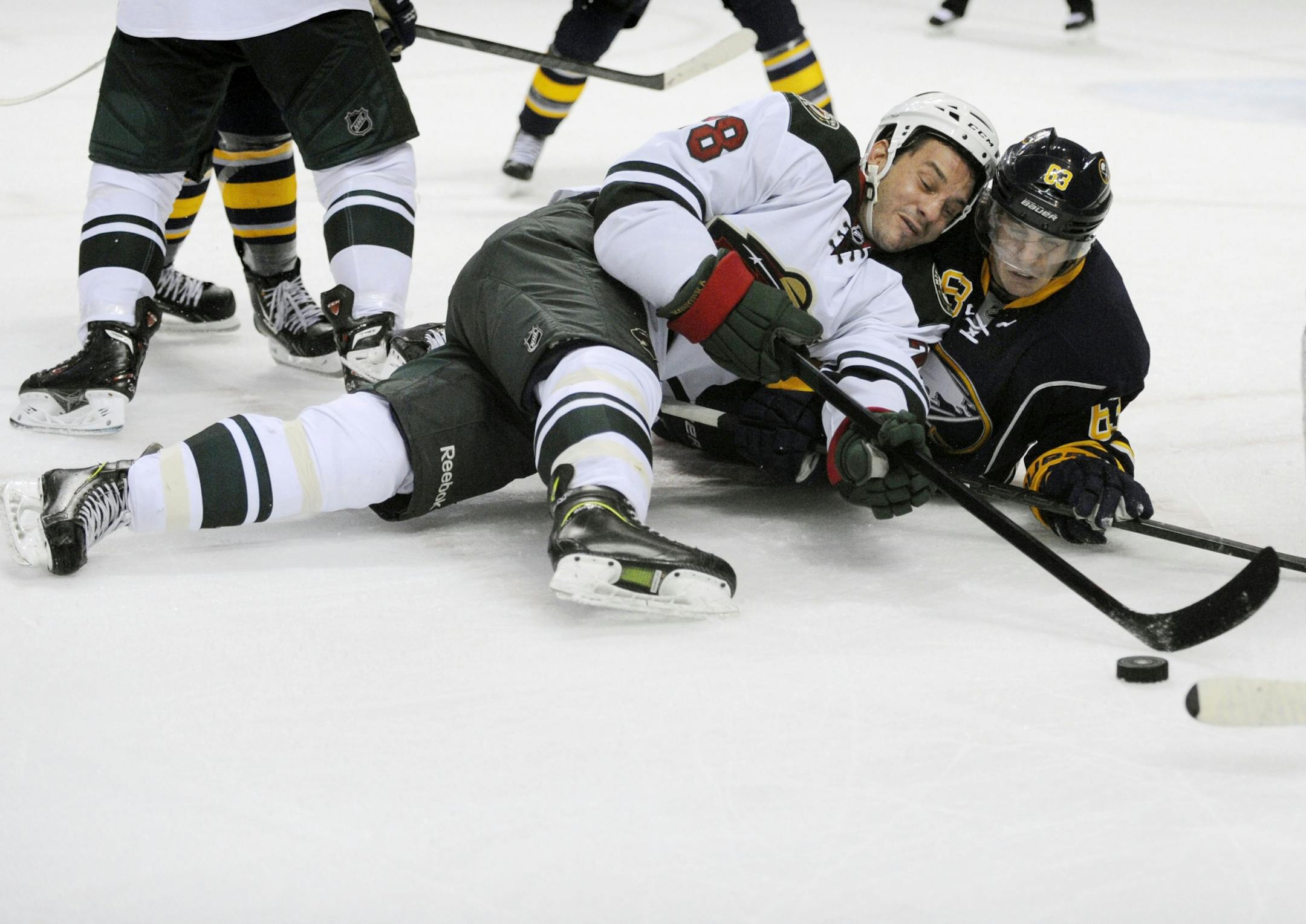 Minnesota Wild center Zenon Konopka (28) battles for the puck with Buffalo Sabres center Tyler Ennis (63) on a face off during the second period of an NHL hockey game in Buffalo, N.Y., Monday, Oct. 14, 2013.