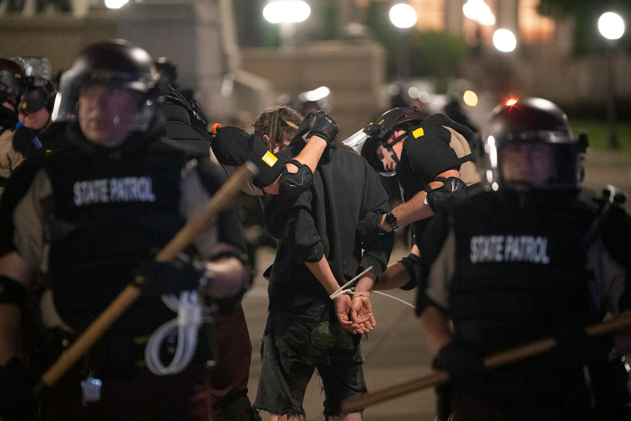 A demonstrator was searched while being arrested.