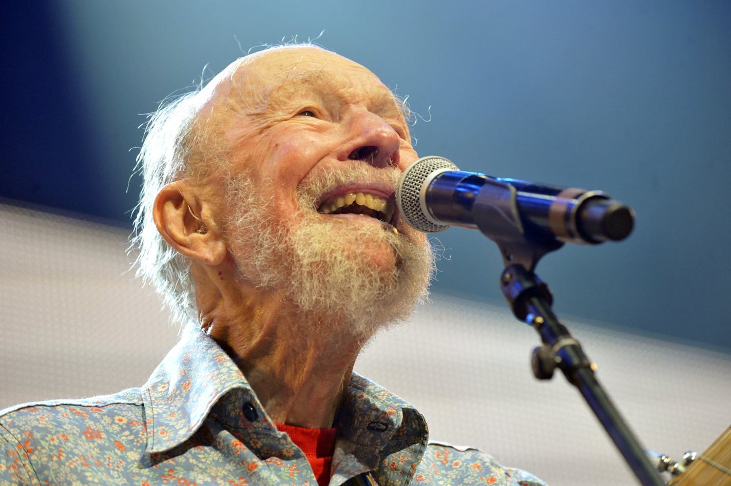 File-This Sept. 21, 2013, file photo shows Pete Seeger performing on stage during the Farm Aid 2013 concert at Saratoga Performing Arts Center in Saratoga Springs, N.Y. The American troubadour, folk singer and activist Seeger died Monday Jan. 27, 2014, at age 94.