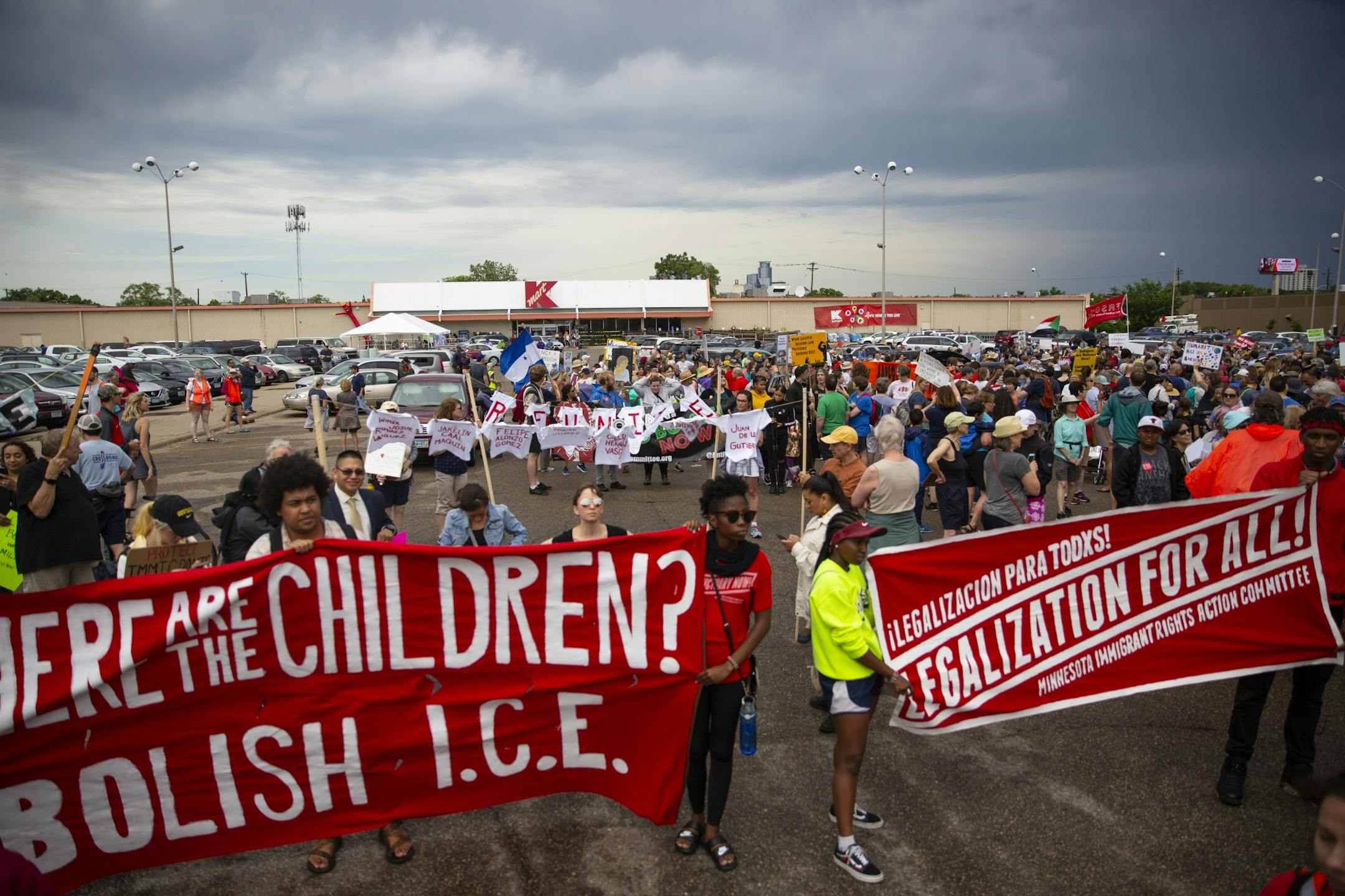 A large crowd gathered in the K-Mart parking lot at the intersection at Lake Street and Nicolette Ave before marching two miles through the streets to the First Universalist Church of Minneapolis. ALEX KORMANN ¥ alex.kormann@startribune.com Approximately 1,000 people marched through the streets of Minneapolis on Sunday June 30, 2019 protesting the treatment of migrants on the U.S. border. "Stop separating families, close the camps," said Mari Mansfield, an organizer for the event.