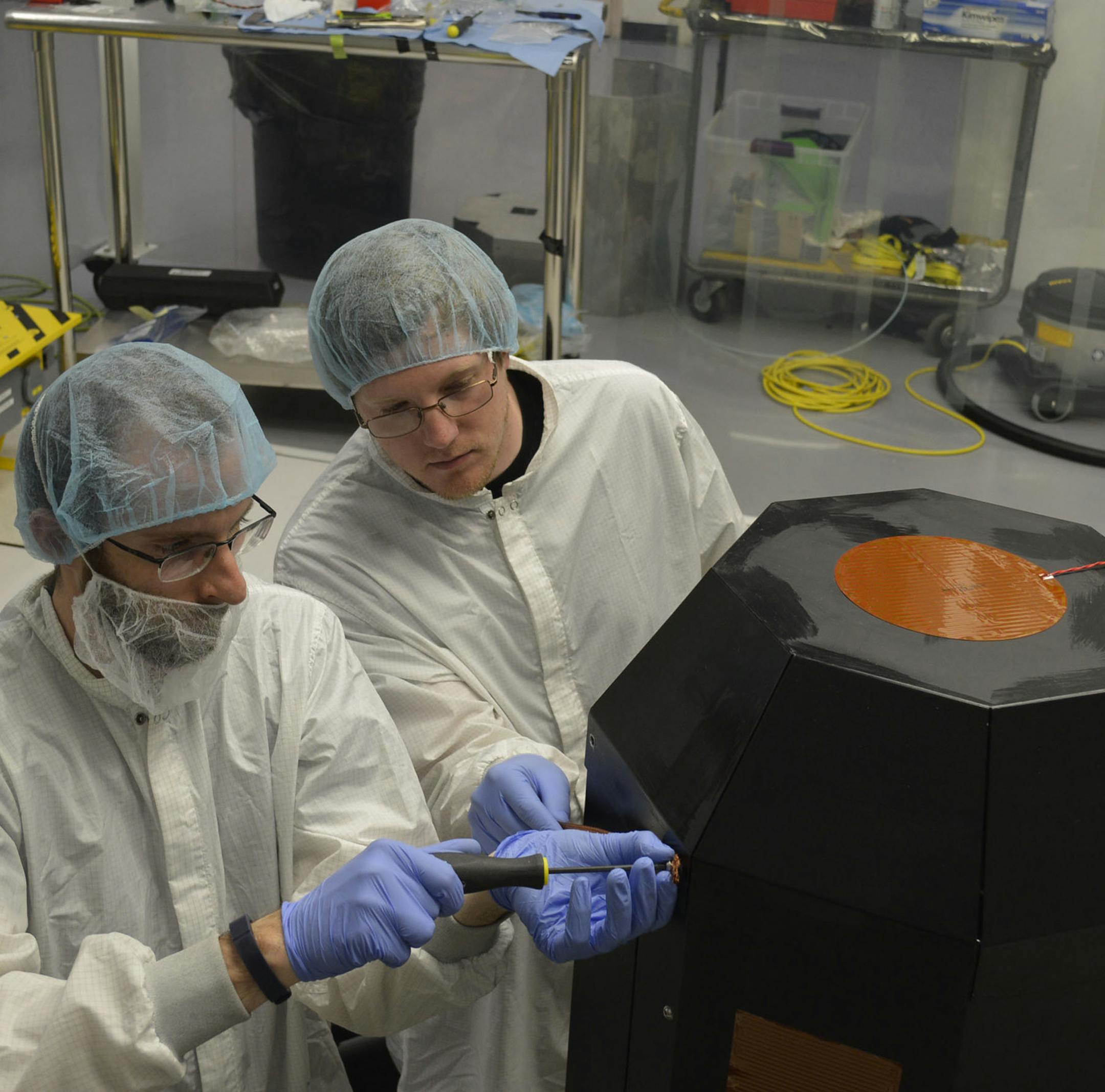 Eric Joyce (left), Archinaut project manager, and DeeJay Riley, engineer, work on the Archinaut, the Made In Space robot the company hopes to send into space to manufacture products in low Earth orbit. The robot will consist of a 3D printer that produces parts, and robotic arms that assemble those parts into a finished product. (Courtesy Made In Space)