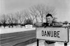 Bob Bruggers stands by a sign in front of his hometown of Danube, Minn., in 1962. Bruggers went on to play for the Gophers and then the NFL.