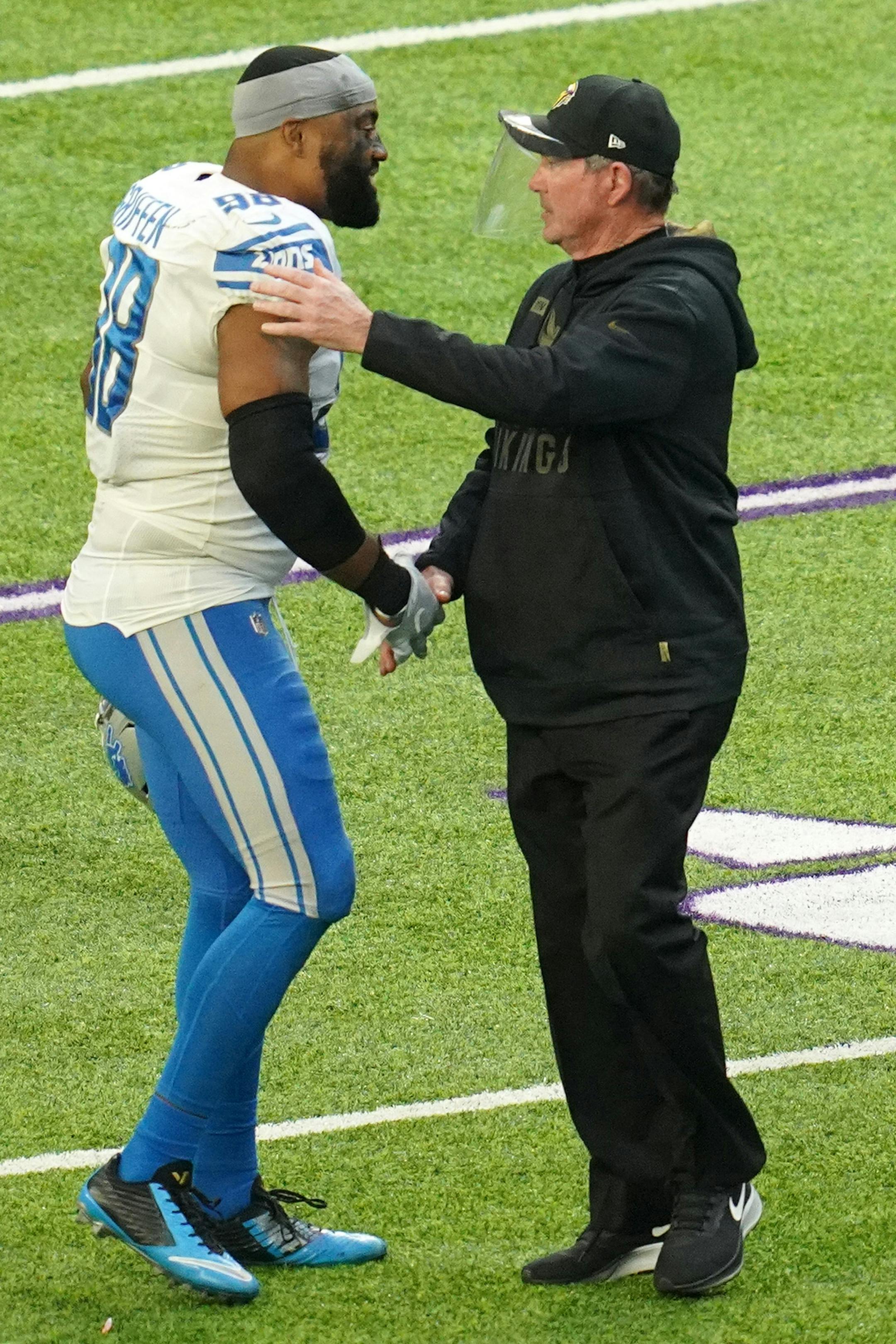 Former Minnesota Vikings player, now Detroit Lions defensive end Everson Griffen (98), greeted his former head coach Mike Zimmer at the end of the fourth quarter.