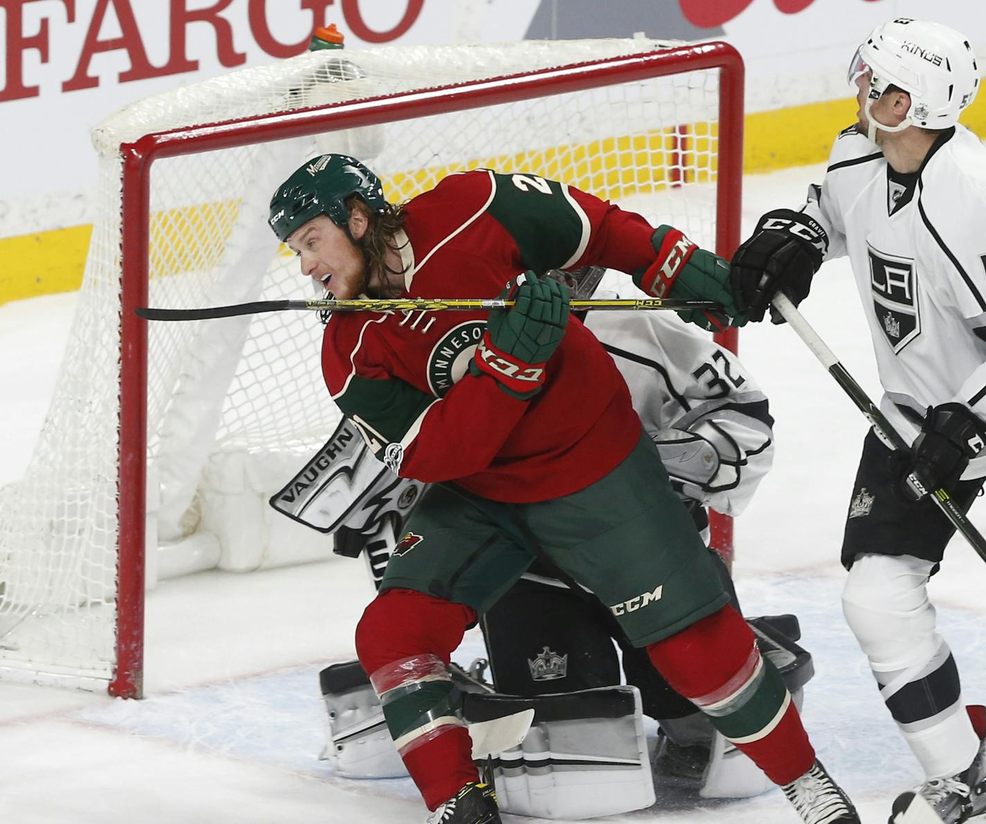 Minnesota Wild's Martin Hanzal, left, makes his way between Los Angeles Kings goalie Jonathan Quick and Kevin Gravel, right, during an NHL hockey game against Los Angeles Kings Monday, Feb. 27, 2017, in St. Paul, Minn. It was Hanzal's debut with the Wild after a trade with the Phoenix Coyotes. The Wild won 5-4 in overtime. (AP Photo/Jim Mone)