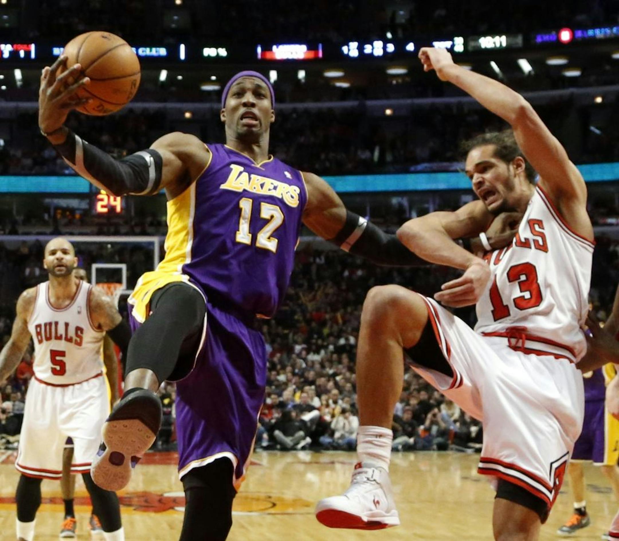 Los Angeles Lakers center Dwight Howard (12) pushes Chicago Bulls center Joakim Noah (13) away from a rebound during the second half of an NBA basketball game Monday, Jan. 21, 2013, in Chicago. The Bulls won 95-83.