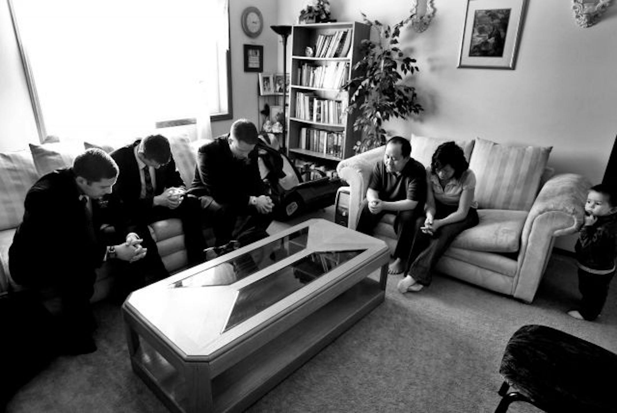. From left, Forsyth, Meyers and Hill prayed with Kao and Kia Ly , who also are members of the Church of Jesus Christ of Latter-day Saints. The Lys' 2½-year-old grandson, Ben, listened in.