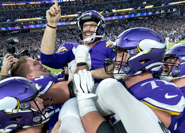 Minnesota Vikings kicker Greg Joseph celebrates with teammates after kicking the game winner in overtime.