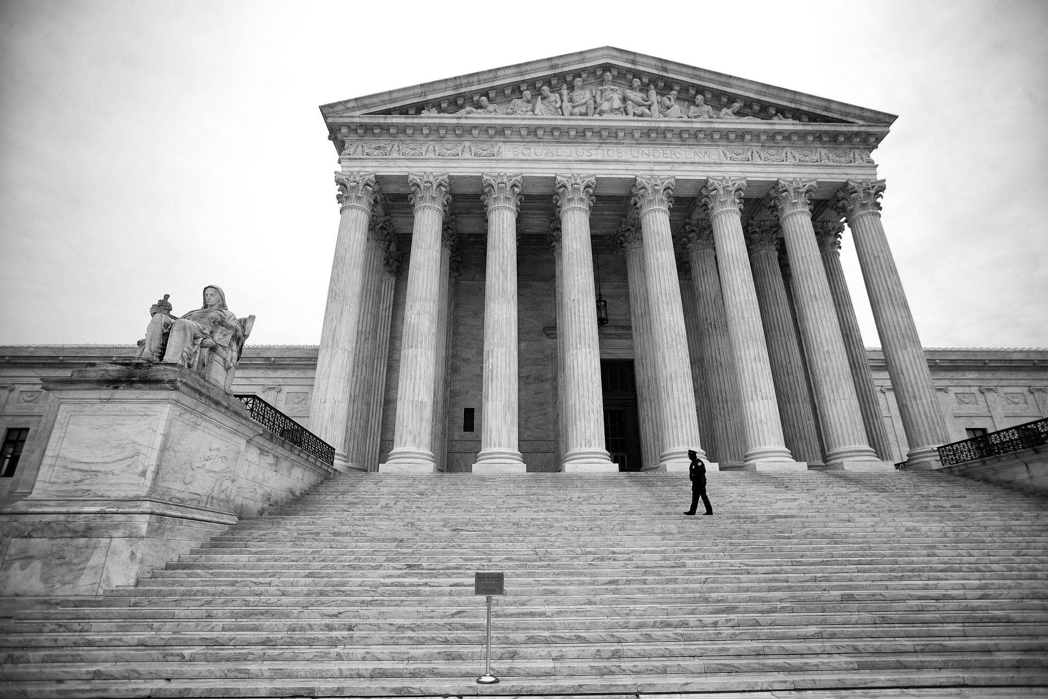An officer patrols the steps of the Supreme Court building, on Capitol Hill in Washington, March 3, 2015.