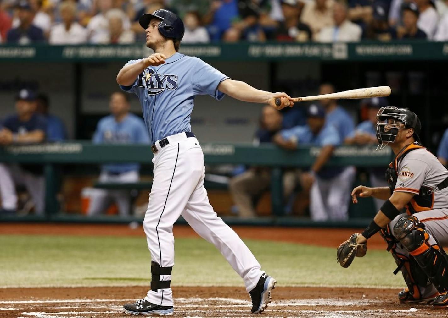 Tampa Bay Rays' Wil Myers, left, watches his two-run home run in front of San Francisco Giants catcher Guillermo Quiroz during the first inning of an MLB inter-league baseball game Sunday, Aug. 4, 2013, in St. Petersburg, Fla.