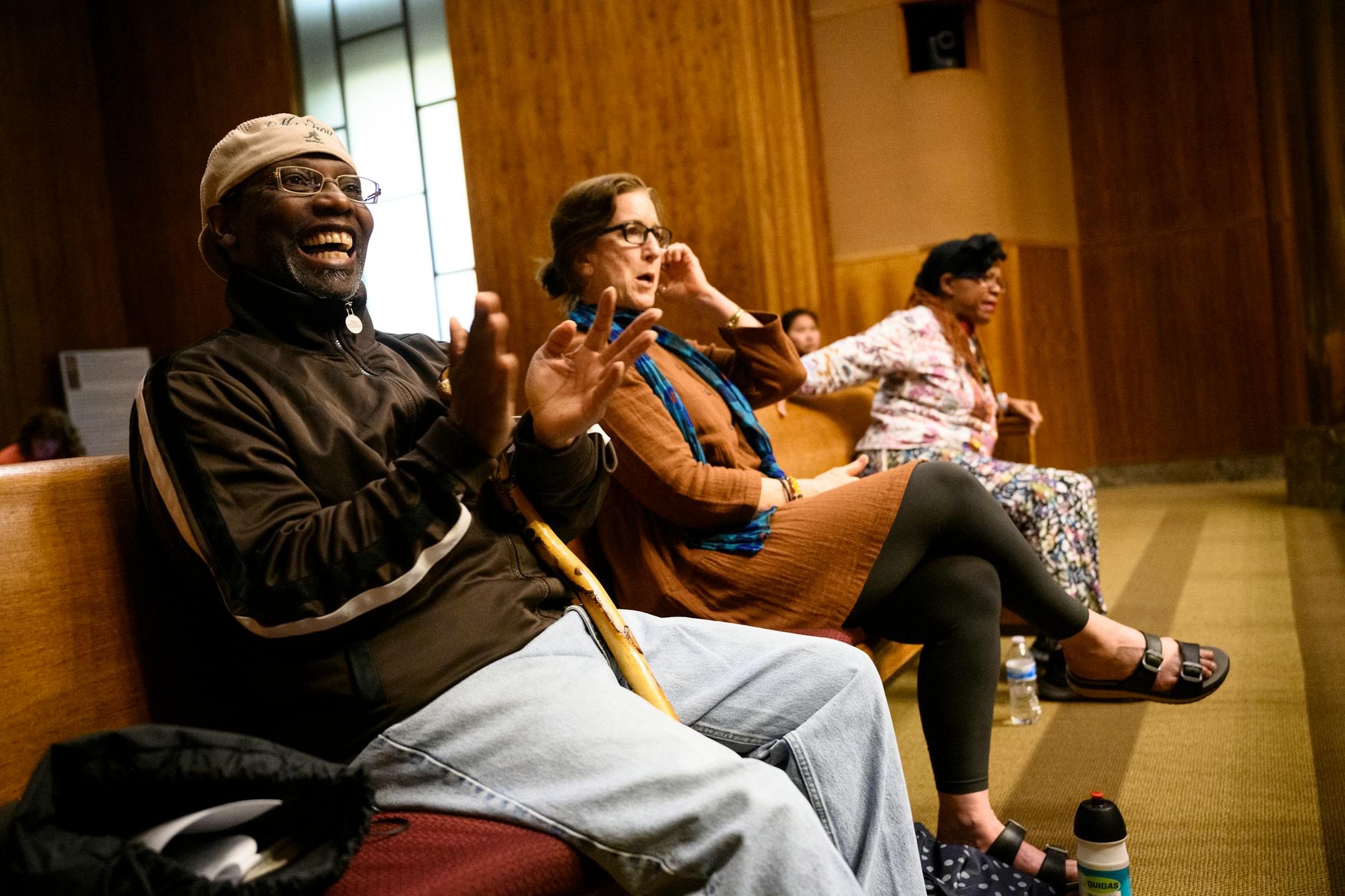 Marcus Troy, of Ward 2, claps for a fellow community member who spoke out against a package of amendments to the St. Paul rent control laws during a city council meeting.