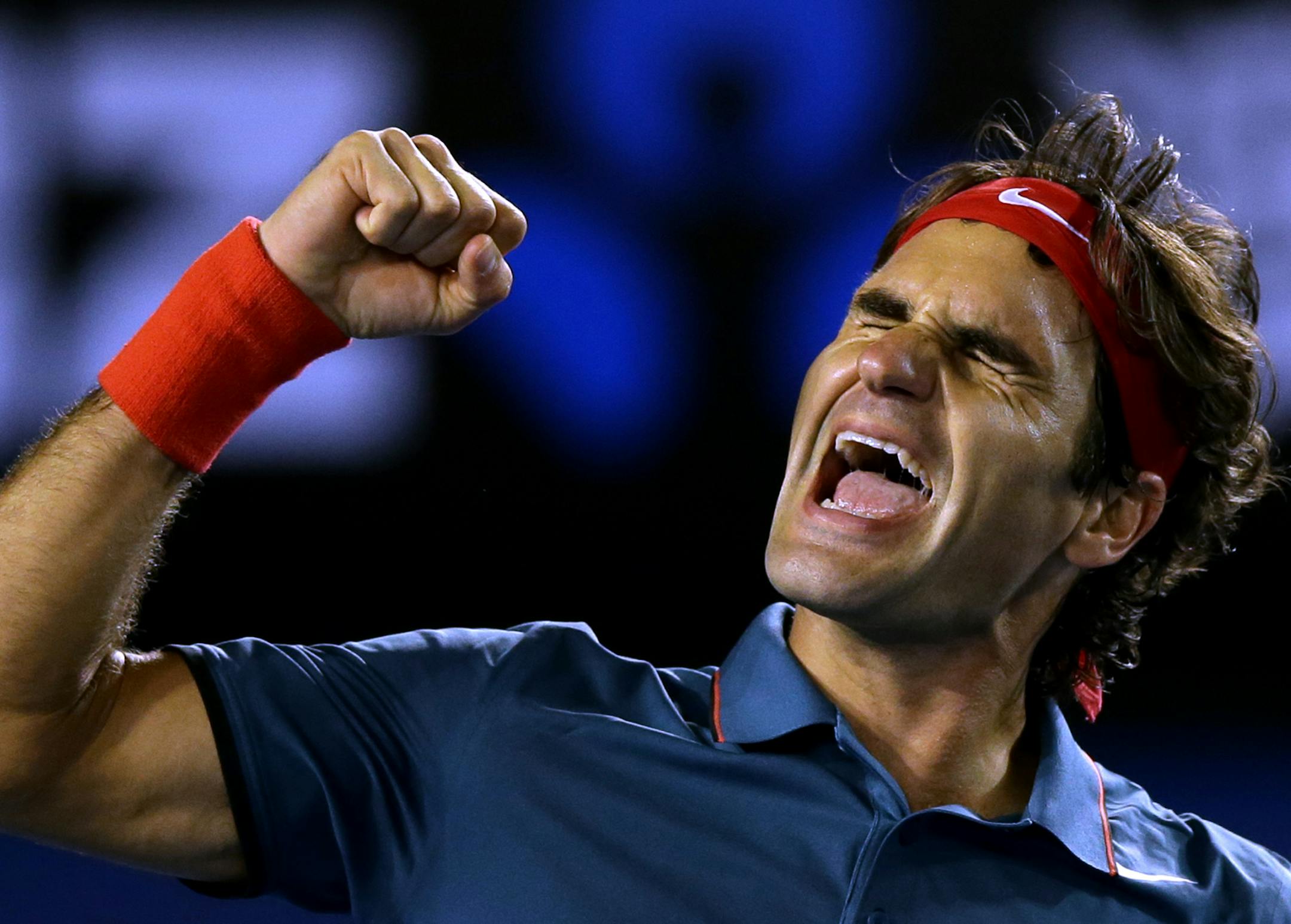 Roger Federer of Switzerland celebrates after defeating Andy Murray of Britain during their quarterfinal at the Australian Open tennis championship in Melbourne, Australia, Wednesday, Jan. 22, 2014.(AP Photo/Aaron Favila)