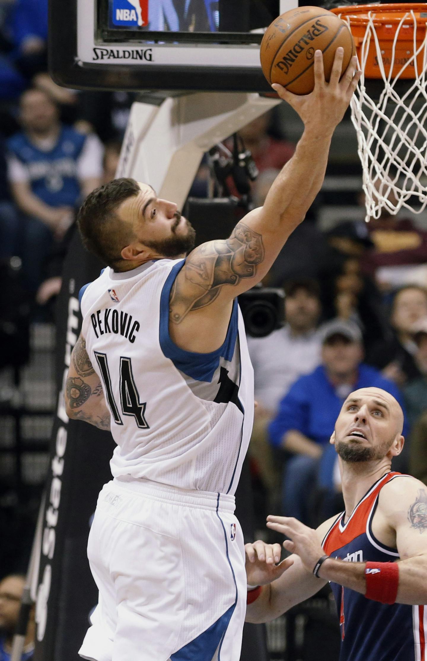 Minnesota Timberwolves&#xed; Nikola Pekovic, left, of Montenegro, grabs a rebound in front of Washington Wizards&#xed; Marcin Gortat of Poland in the second half of an NBA basketball game, Wednesday, Feb. 25, 2015, in Minneapolis. The Timberwolves won 97-77. Gortat had 15 rebounds while Nikola had 13. (AP Photo/Jim Mone) ORG XMIT: MIN2015040320214355