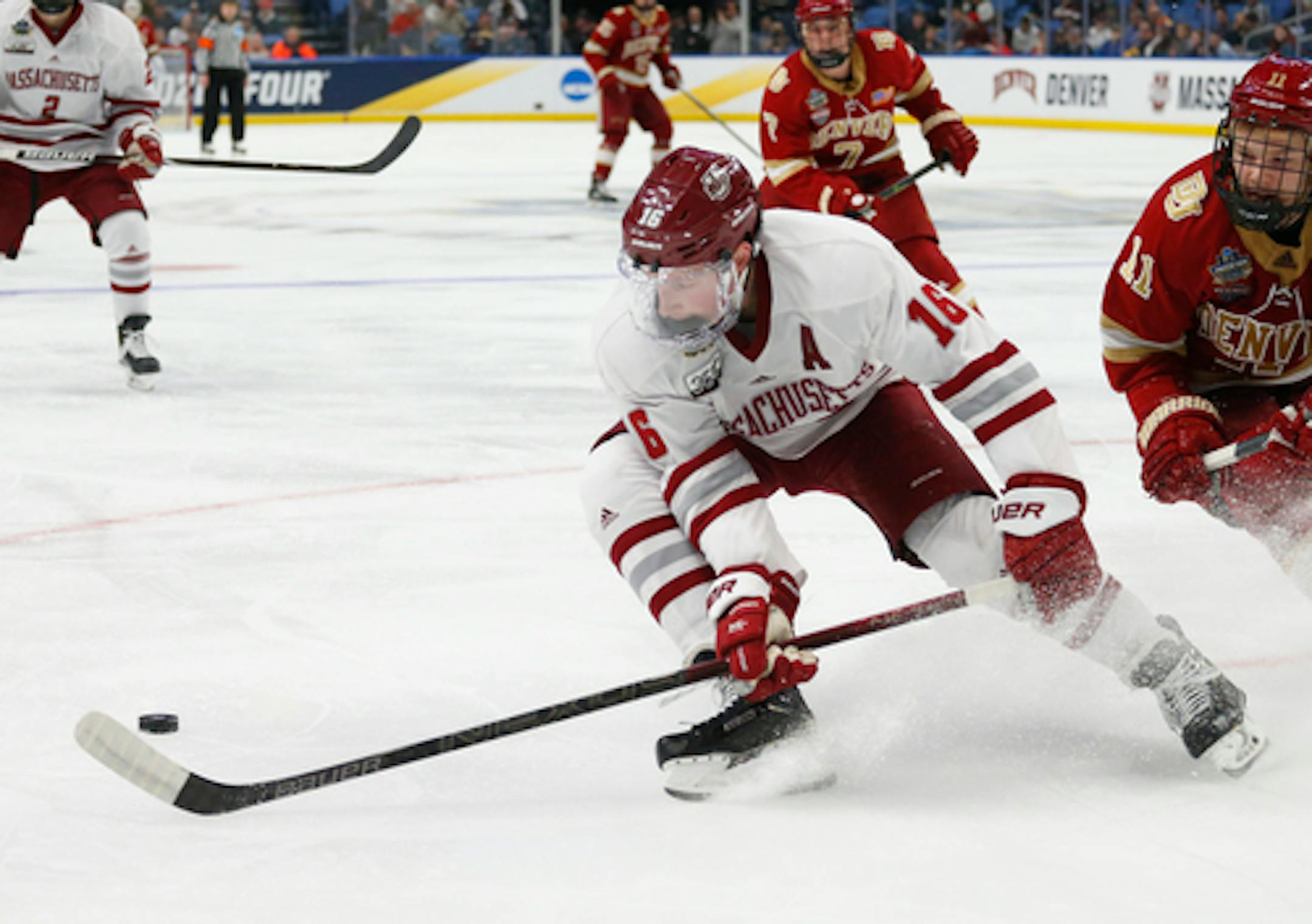 Massachusetts defenseman Cale Makar (16) controls the puck during the second period in a semifinal against Denver during the Frozen Four NCAA men's college hockey tournament Thursday, April 11, 2019, in Buffalo, N.Y. (AP Photo/Jeffrey T. Barnes)