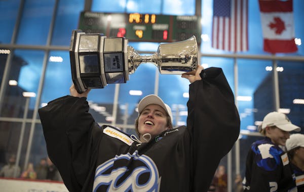 Minnesota Whitecaps goalie Amanda Leveille celebrates with the Isobel Cup at TRIA Rink on Sunday, March 17, 2019 in St. Paul, Minn. The Whitecaps beat