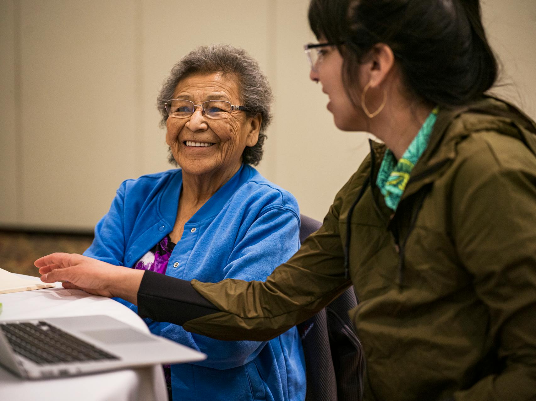 Anton Treuer's daughter Madeline (right) transcribed the stories of native Ojibwe speaker Carol Nickaboine (left).