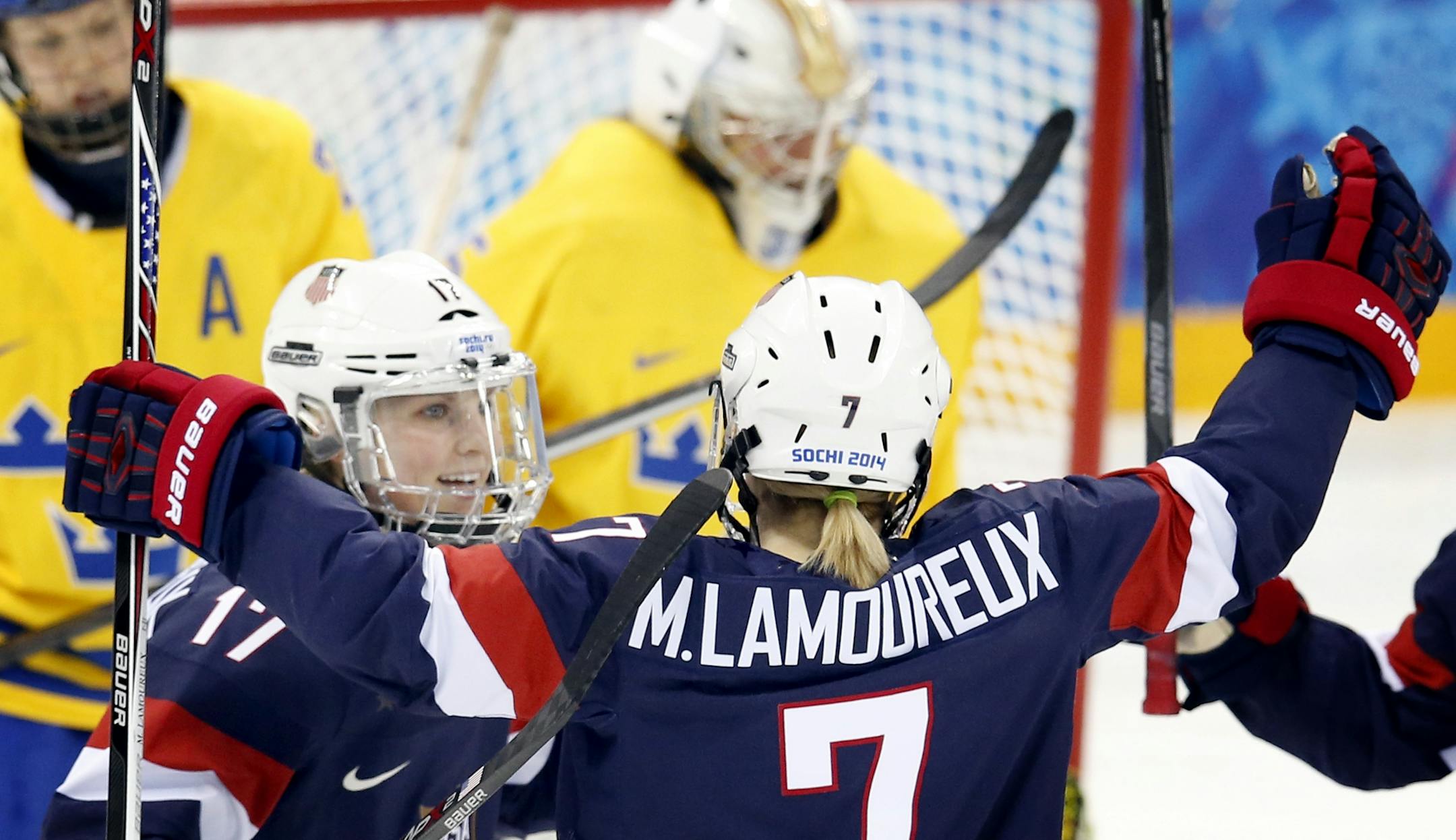 Monique Lamoureux (7) celebrated with teammates after scoring a goal in the second period. USA beat Sweden by a final score of 6-1.