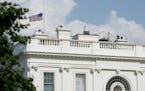 The American flag files at half-staff at the White House, Monday afternoon, Aug. 27, 2018, in Washington. Two days after Sen. John McCain's death, Pre