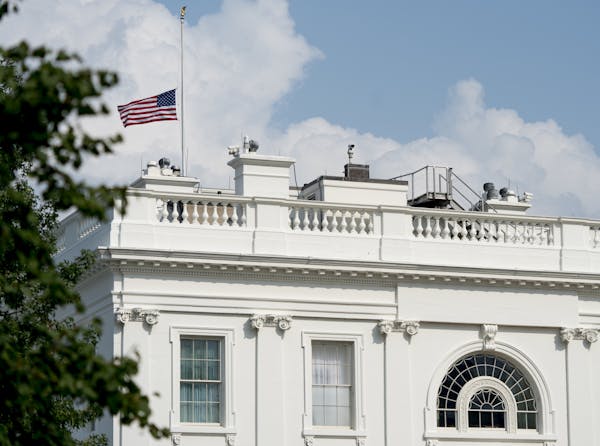 The American flag files at half-staff at the White House, Monday afternoon, Aug. 27, 2018, in Washington. Two days after Sen. John McCain's death, Pre