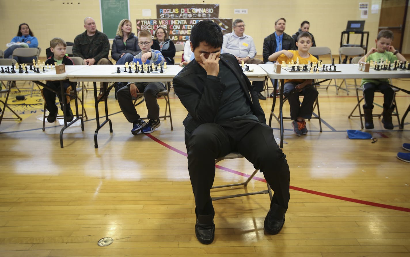 Chess Grandmaster Wesley So covered his face as he played blind chess against ten students from the chess club of Robbinsdale's Spanish Immersion School in New Hope, Minn., on Friday March 6, 2015. ] RENEE JONES SCHNEIDER &#x2022; reneejones@startribune.com