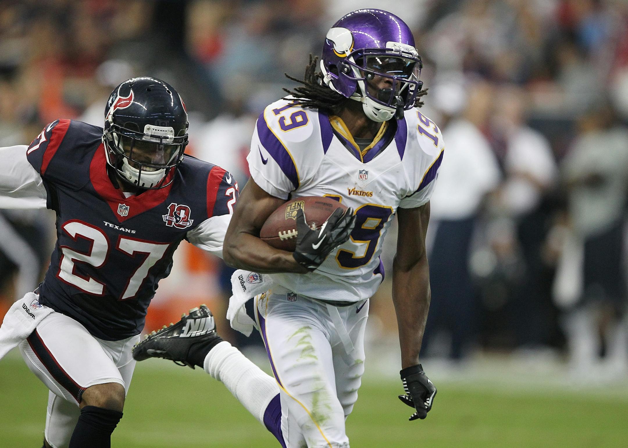 Minnesota wide receiver Devin Aromashodu (19) scored a touchdown ahead of Houston safety Quintin Demps (27).