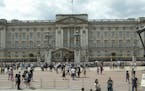 FILE - In this file photo dated Wednesday, June 24, 2015, tourists view the front facade of Buckingham Palace, the official London residence of Britai