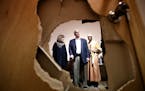 Lt. Gov. Tina Smith left, Gov. Mark Dayton and Imam Ahmed Sheikomar Ibrahim looked at a door that was damaged when some one broke into and burglarized