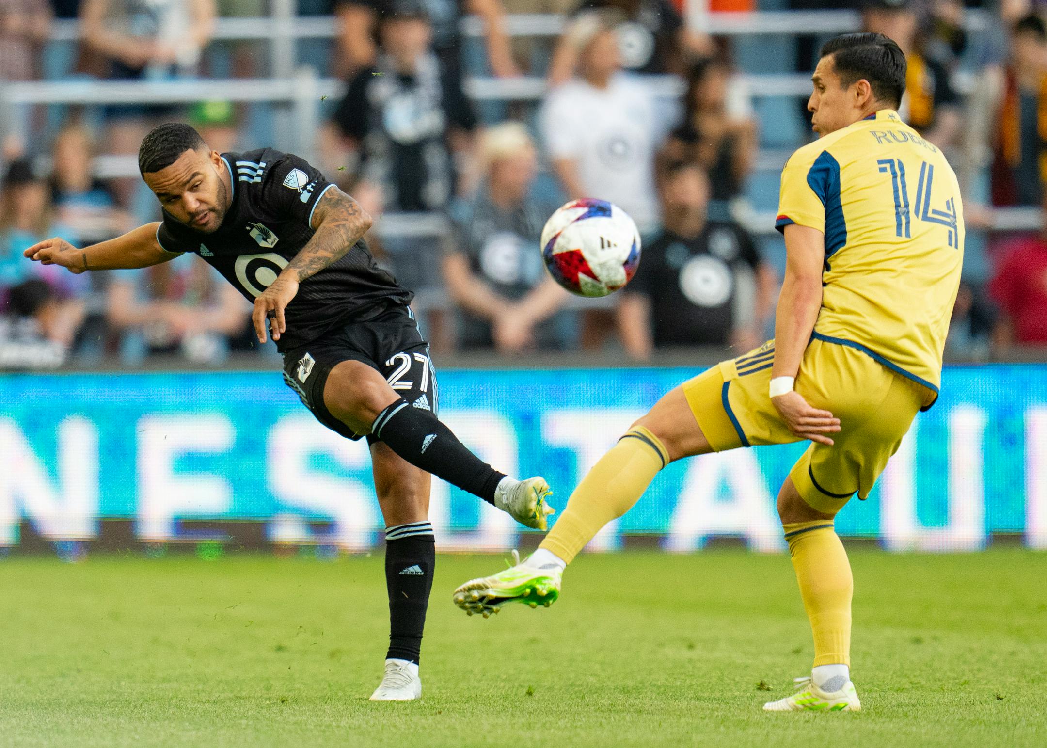 Minnesota United defender D.J. Taylor (27) passes the ball around Real Salt Lake forward Rubio Rubin (14) in the first half Saturday, May 27, 2023, at Allianz Field in St. Paul, Minn.