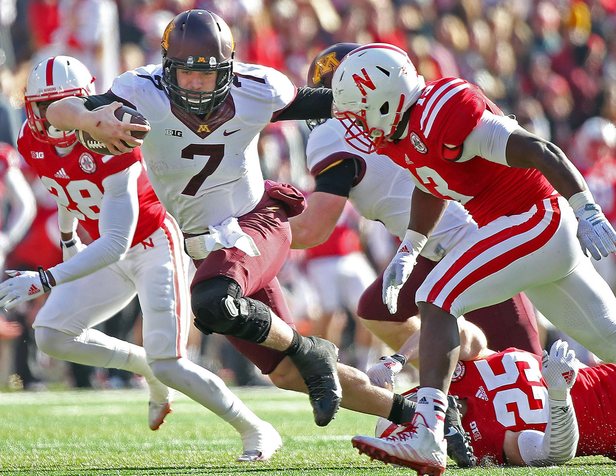 Minnesota's quarterback Mitch Leidner (7) ran for a first down despite defensive pressure by Nebraska's defensive back Nate Gerry (25) in the third quarter as the Minnesota Gophers took on the Nebraska Cornhuskers at Memorial Stadium, Saturday, November 22, 2014 in Lincoln, NE. ] (ELIZABETH FLORES/STAR TRIBUNE) ELIZABETH FLORES • eflores@startribune.com