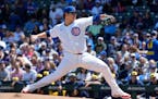 Cubs starting pitcher Javier Assad throws against the Brewers during the first inning Sunday in Chicago.