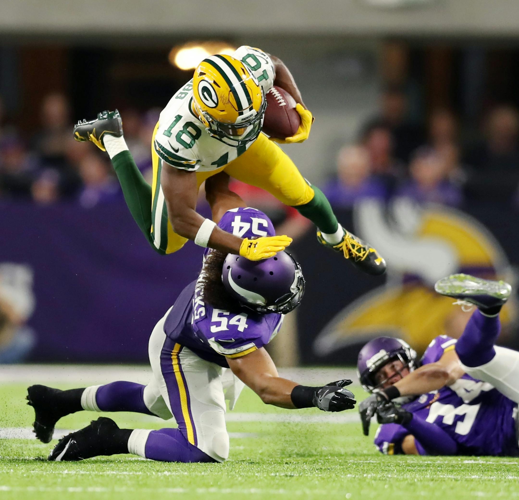 Green Bay's Randall Cobb dives over Vikings Eric Kendricks for the 1st down in the 1st quarter. The Minnesota Vikings open the new US Bank Stadium for their first home regular season game against the Green Bay Packers. Here,