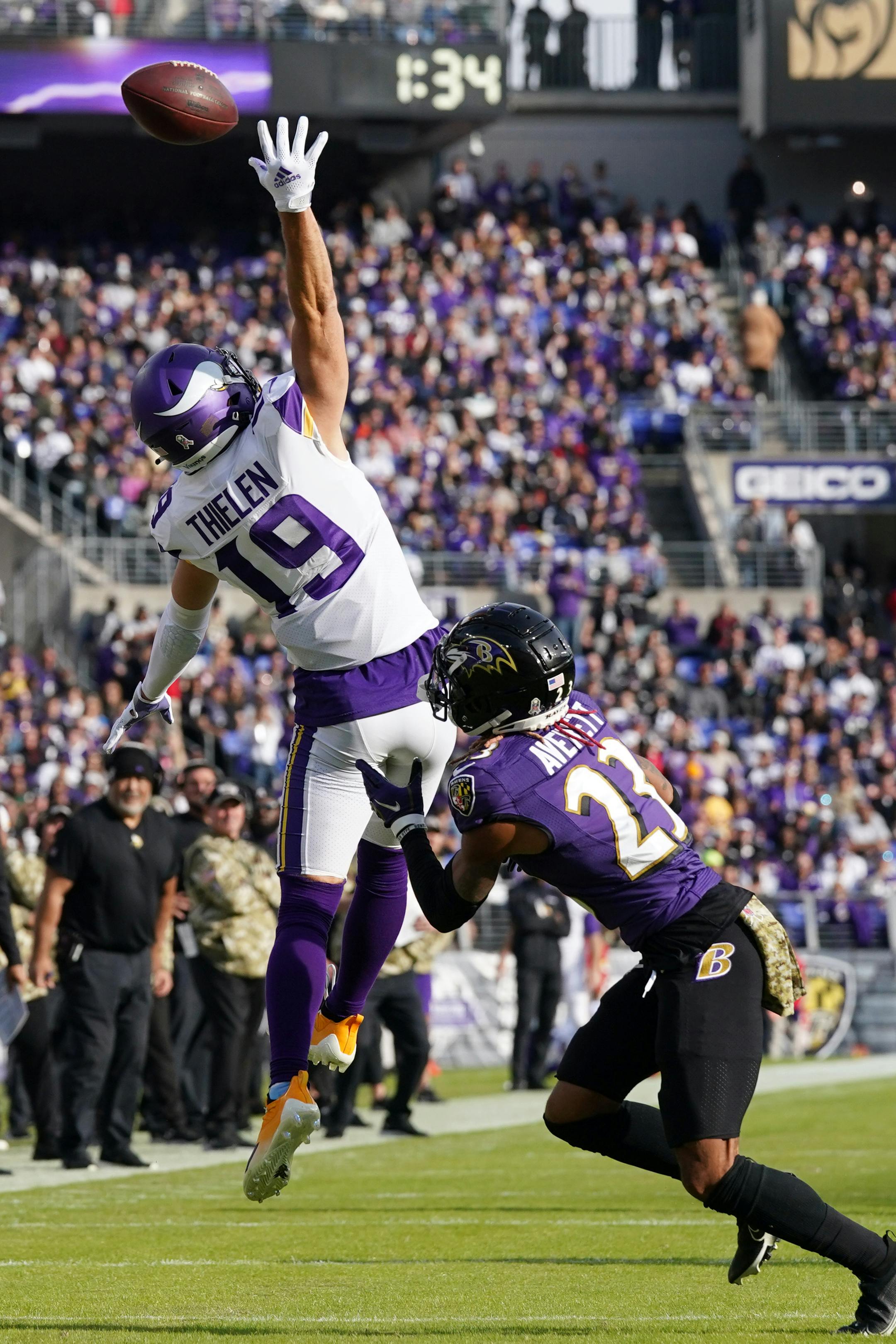 Vikings wide receiver Adam Thielen (19) was unable to grab a touchdown pass overthrown by quarterback Kirk Cousins (8) as Ravens cornerback Anthony Averett (23) defended in the second quarter.