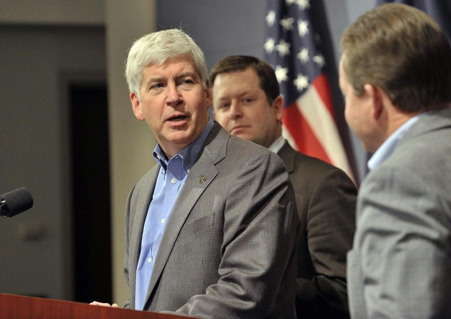 Michigan Gov. Rick Snyder, flanked by Speaker of the House Jase Bolger, left, and Senate Majority Leader Randy Richardville, announces a new incentive plan for Detroit Wednesday Jan. 22, 2014 in Lansing, Mich.