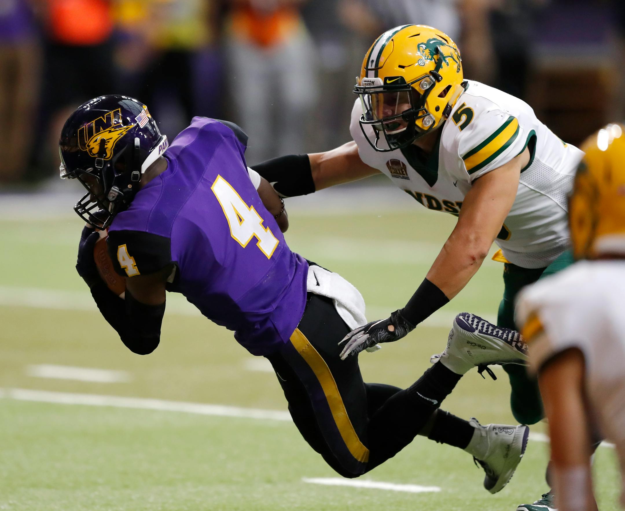 Northern Iowa wide receiver Deion McShane catches a 26-yard touchdown pass ahead of North Dakota State safety Robbie Grimsley (5) during the second half of an NCAA college football game, Saturday, Oct. 6, 2018, in Cedar Falls, Iowa. North Dakota State won 56-31. (AP Photo/Charlie Neibergall)