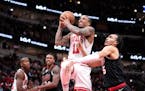 The Bulls' DeMar DeRozan (11) drives to the basket and is fouled by the Trail Blazers' Dalano Banton, right, during the first half Monday in Chicago.