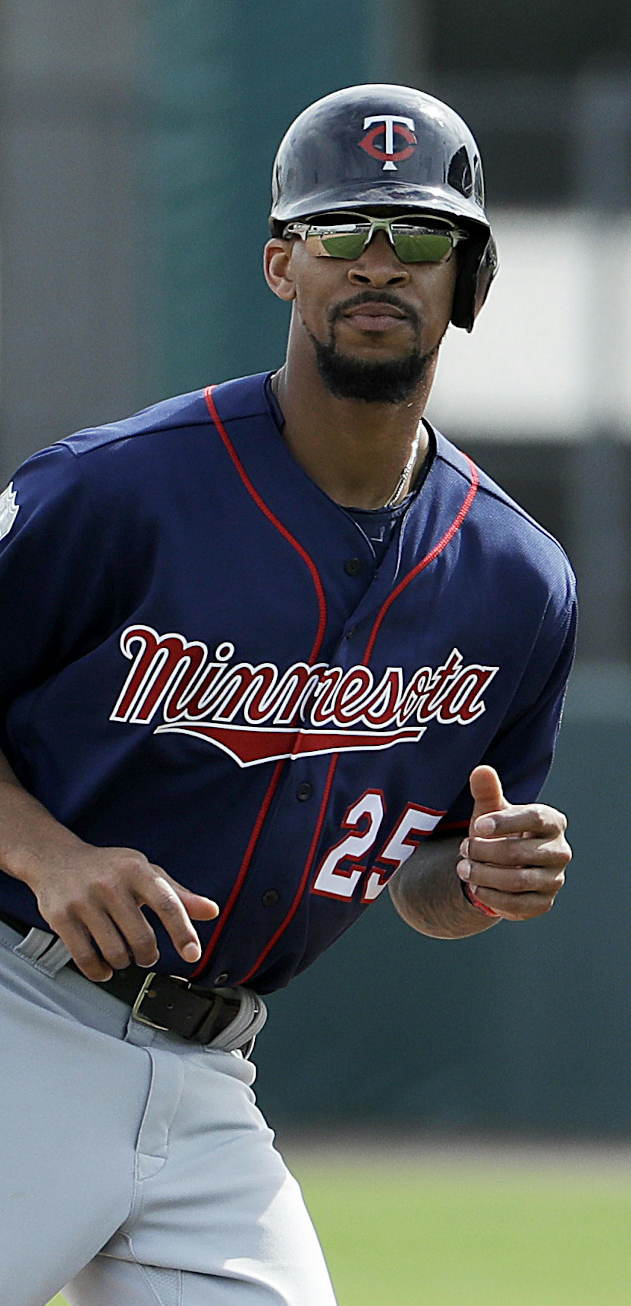 FILE - In this Feb. 21, 2017, file photo, Minnesota Twins' Byron Buxton runs on the field during a spring training baseball workout in Fort Myers, Fla. Buxton's first major league stints weren't so smooth, but the Twins have full faith in their former No. 2 overall draft pick. Despite going 0 for 5 with three strikeouts in the season opener Monday, April 3, in the No. 3 spot in the lineup, Buxton made two diving catches of sinking line drives in center field. (AP Photo/David Goldman, File)