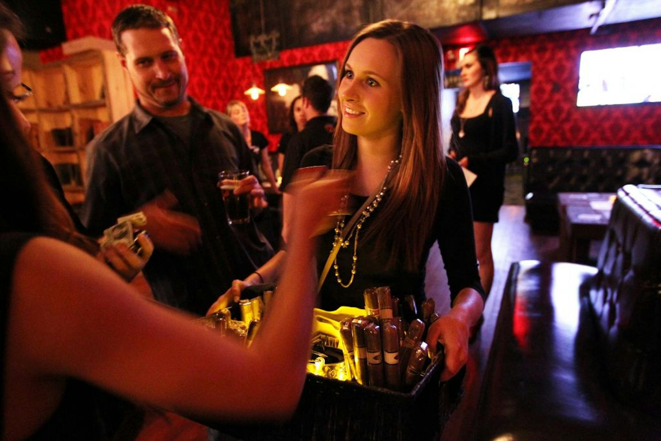 Anna Finanger sells cigars for the Havana Cigar Boutique at the grand opening of the Pourhouse in downtown Minneapolis June 1, 2012. The cigars could not, of course, be smoked indoors.