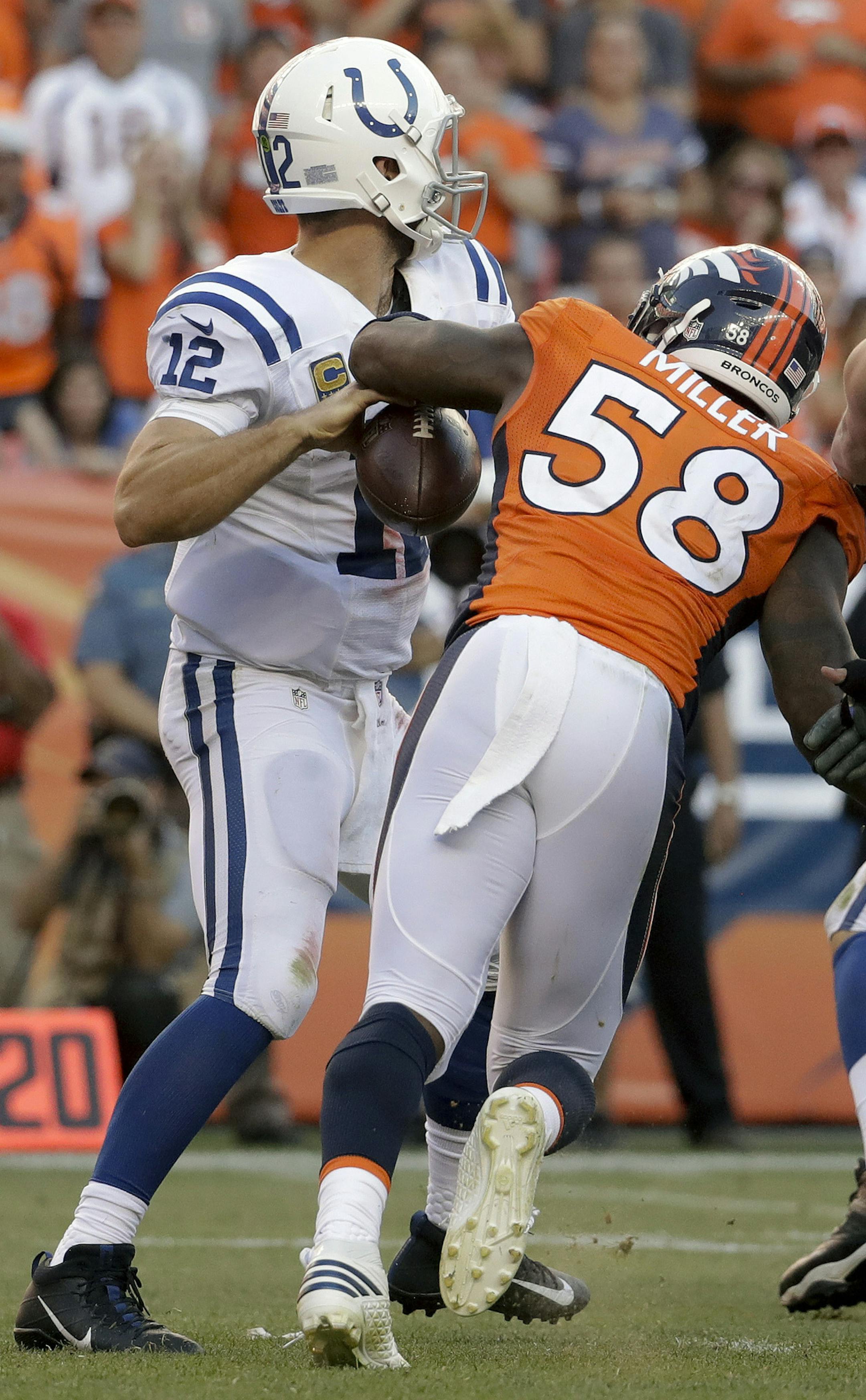 Denver Broncos outside linebacker Von Miller, right, forces a fumble by Indianapolis Colts quarterback Andrew Luck during the second half in an NFL football game, Sunday, Sept. 18, 2016, in Denver. (AP Photo/Jack Dempsey)