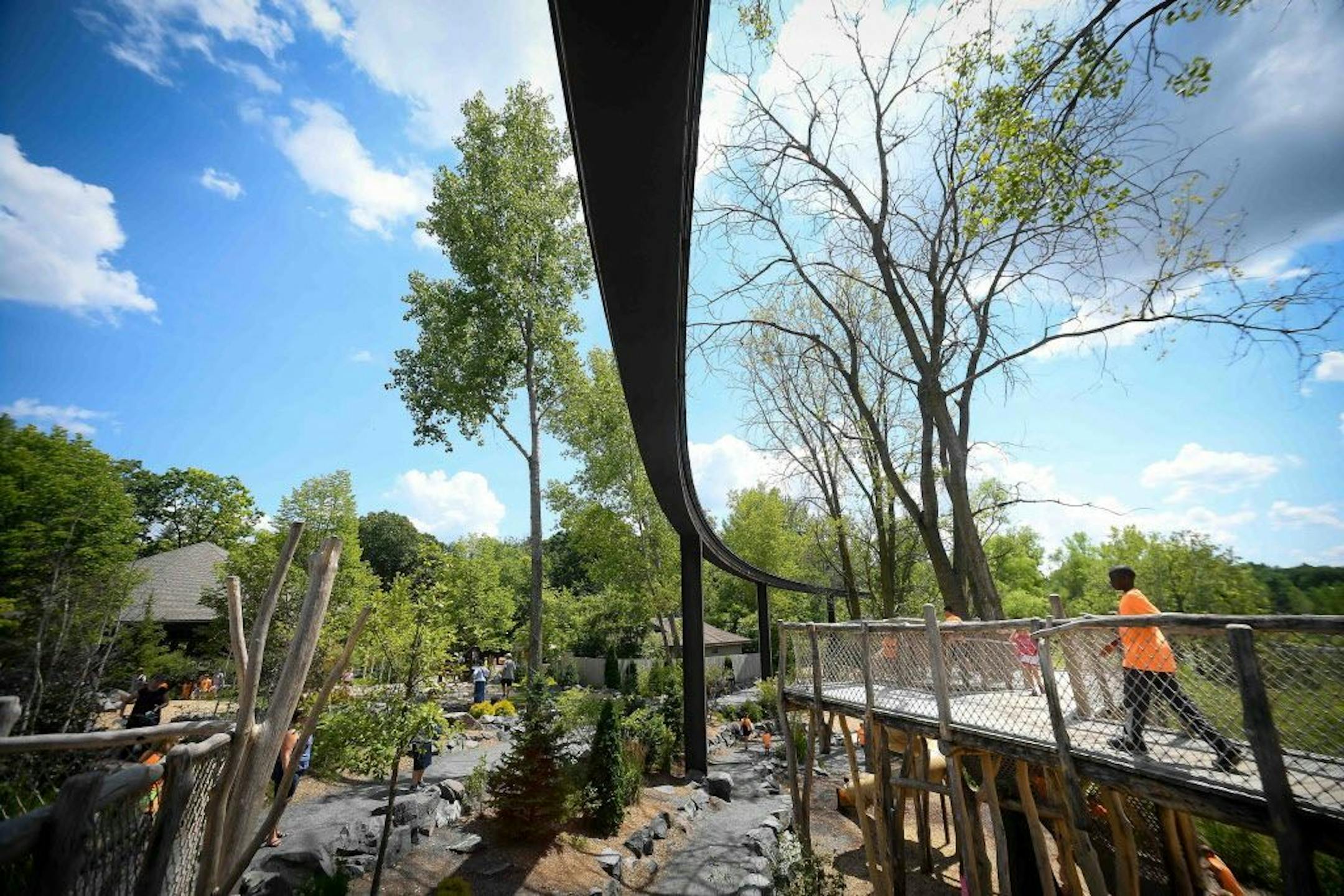The defunct monorail track passes above the Hanifl Family Wild Woods Play Area at the Minnesota Zoo in Apple Valley.