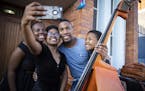 Associate conductor Roderick Cox posed for a photo with members of the South African National Youth Orchestra during the Minnesota Orchestra's 2018 tr