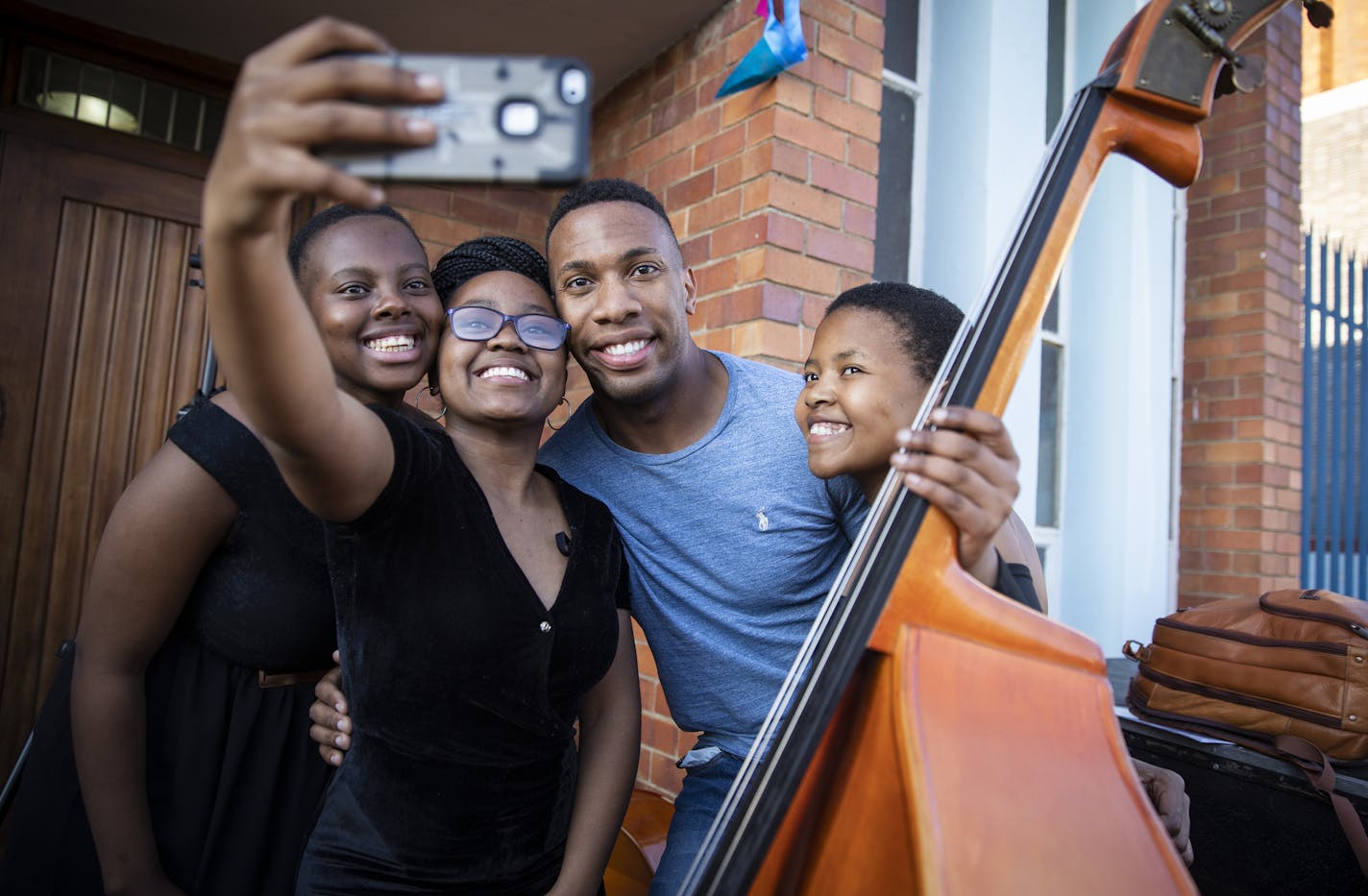 Associate conductor Roderick Cox posed for a photo with members of the South African National Youth Orchestra during the Minnesota Orchestra's 2018 trip to Johannesburg.