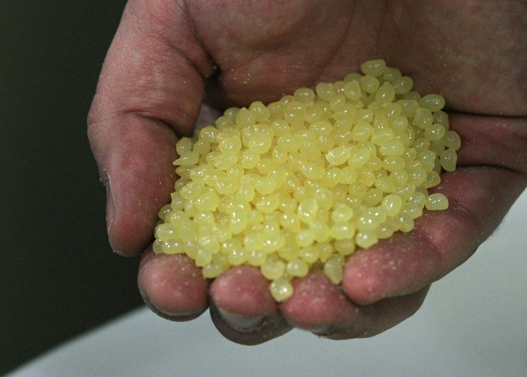 Nick Long, Graco Global Product Marketing Manager, held pelletized adhesive, part of a new hot glue process being used at Summit Brewing to glue boxes. Photographed on 2/13/13. Graco has launched a new line of equipment that dispenses packaging glue. Test launch is in the Summit Brewing Co. The new equipment, which applies glue, is a departure for Graco, which is better known for making sprayers that apply paint, powder, insulation and lubricants. Bruce Bisping/Star Tribune bbisping@startribune.