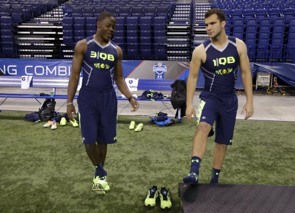 Louisville quarterback Teddy Bridgewater, right, talks with Central Florida quarterback Blake Bortles at the NFL football scouting combine in Indianap
