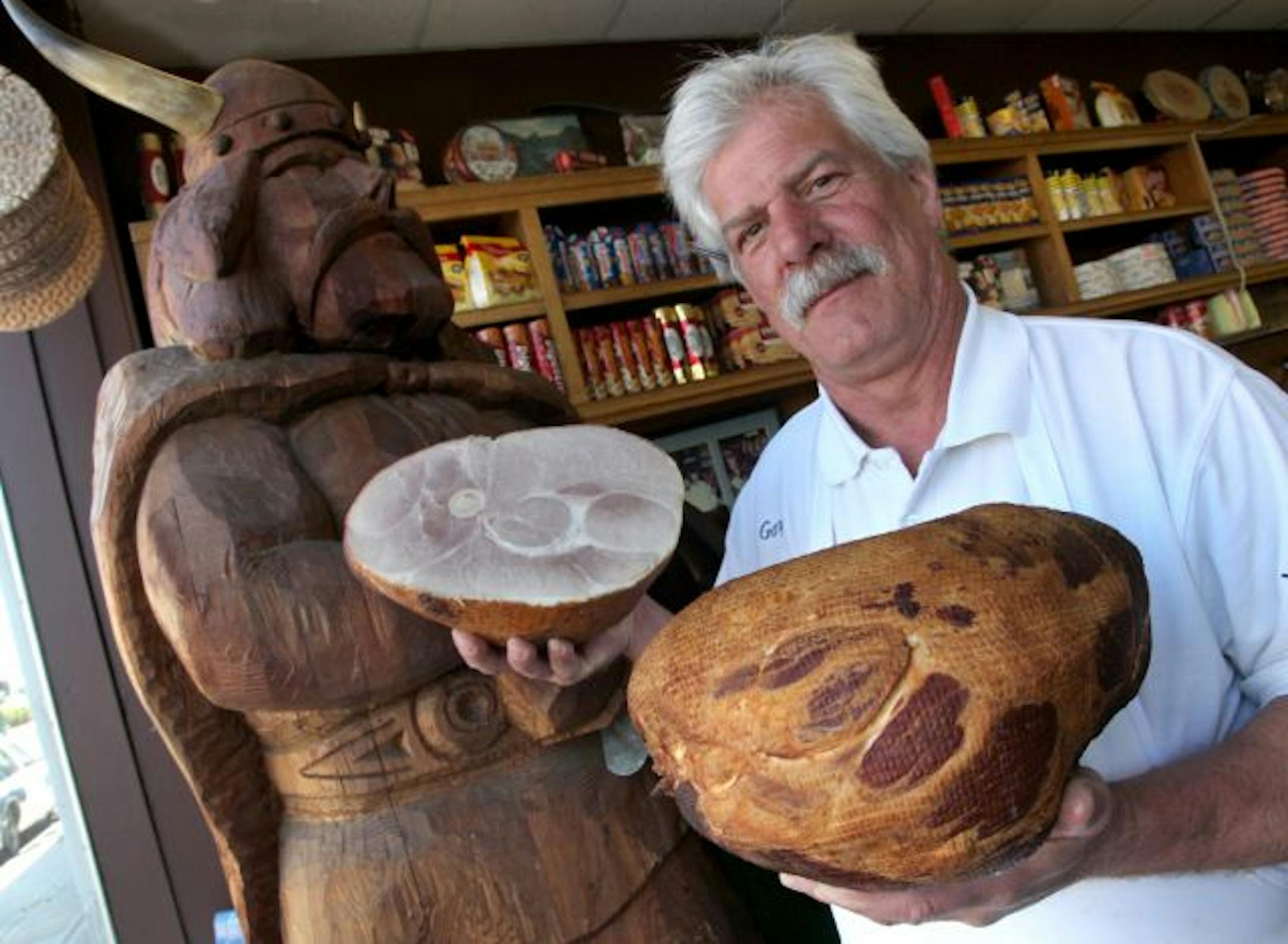 The smoked hams at Ingebretsen's, held by 40 year veteran of the meat counter, Gary Coleman.