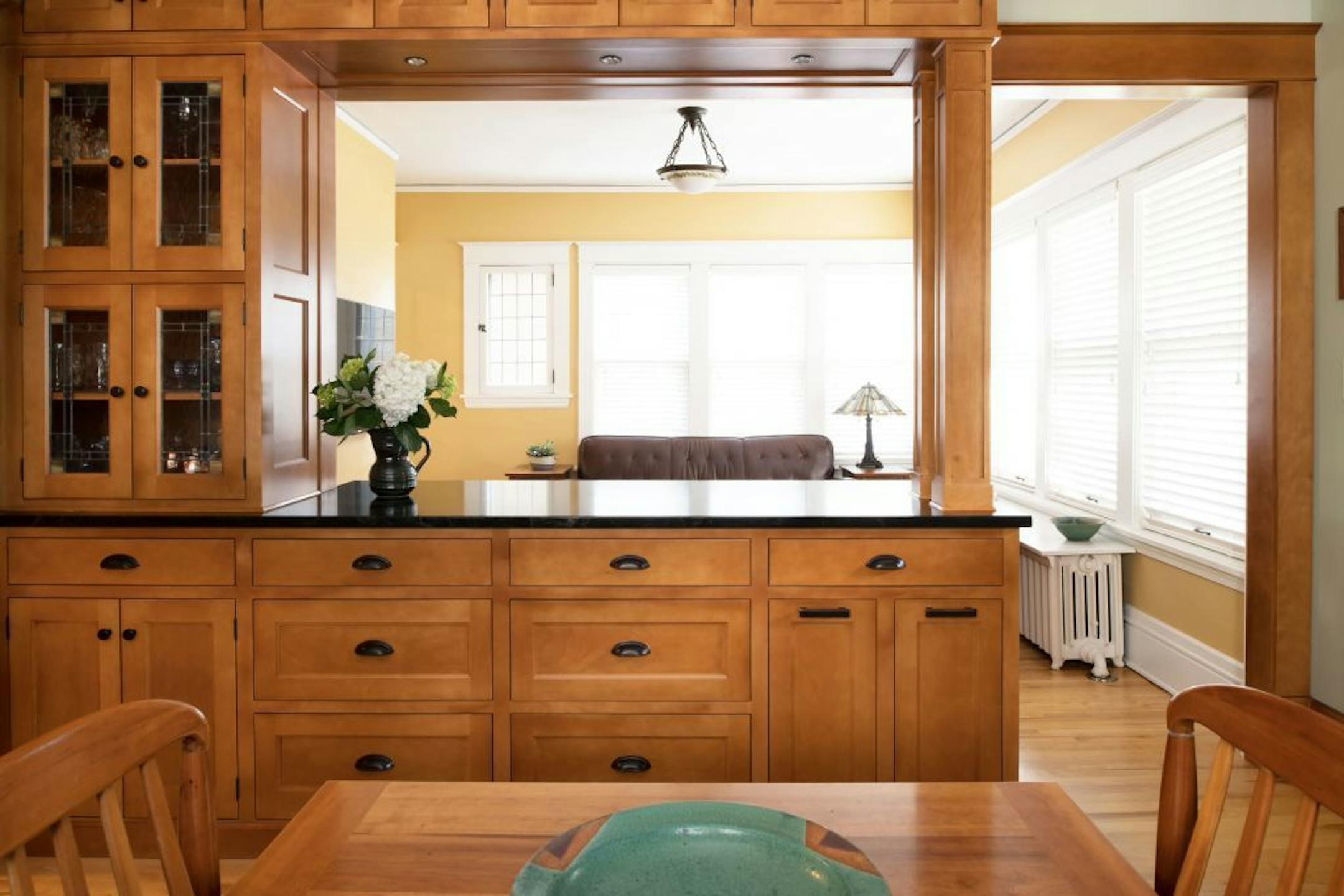 This new Craftsman-inspired kitchen in a century-old Minneapolis home is now open to the adjacent sunroom.