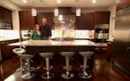 Judy Engel and Peter Schulzetenberg in their dream kitchen. Schulzetenberg designed and built the Italian ebony cabinets, along with the bathroom cabi